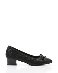 Black shoe with a bow on a white background