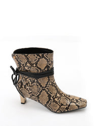 Snake print ankle boot with black interior on a white background