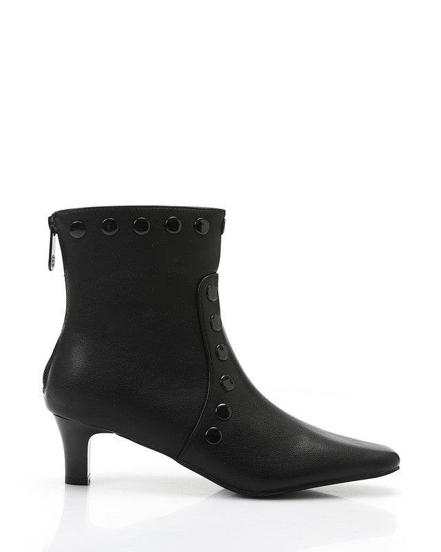 Black ankle boot with decorative elements on a white background
