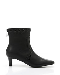 Black ankle boot with decorative elements on a white background